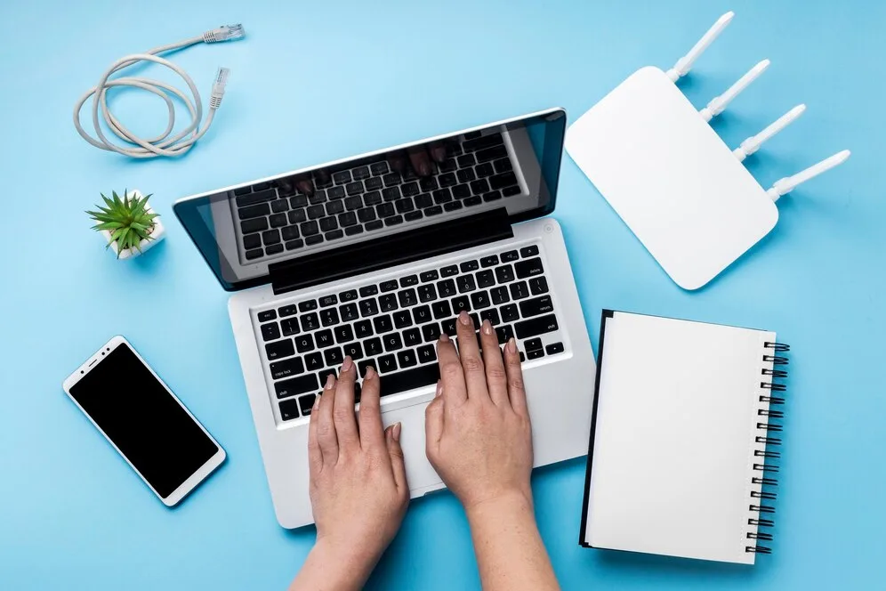 Laptop and Wi-Fi router used to troubleshoot a missing wireless connection in Windows 11