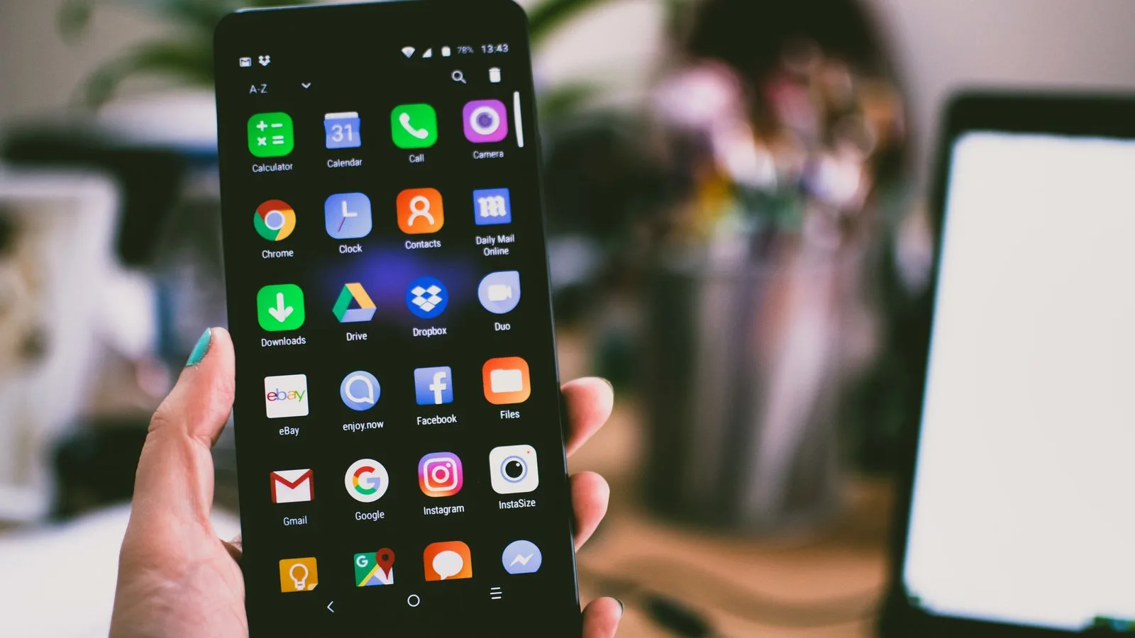 Smartphone displaying colorful app icons, illustrating iOS 27 Liquid Glass display customization